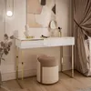 A vanity table with a stool in a well-decorated room. Produktbild-Vorschau