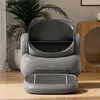 An automatic cat litter box is shown in a well-lit room with a plant in the background. Anteprima dell’immagine prodotto