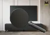 A modern living room with a black TV cabinet and a large black TV mounted on the wall. A magnifying glass is placed in front of the TV, highlighting a herringbone pattern on the cabinet. Náhled obrázku produktu