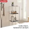 A modern shelving unit with decorative items and a coat rack in the background. Produktbild-Vorschau