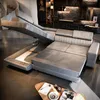 A modern living room with a sectional sofa that has a pull-out bed and storage compartment. Produktbild-Vorschau