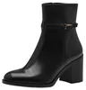 A black leather ankle boot with a block heel and a decorative strap with a gold buckle. Produktbild-Vorschau