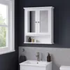 A white bathroom cabinet with mirrored doors is mounted on a dark gray wall above a sink. Náhled obrázku produktu