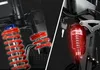 A split image showing close-ups of bicycle suspension systems. Produktbild-Vorschau