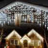 Collage of two images showing houses decorated with white icicle string lights for Christmas. Produktbild-Vorschau