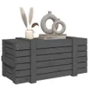 A gray wooden chest with decorative items on top, including vases and books, set against a white background. Náhled obrázku produktu