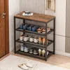 A shoe rack with shoes on display in a hallway next to a door. Podgląd zdjęcia produktu
