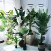 A collection of artificial plants with LED grow lights in a room setting. Náhľad obrázku produktu