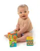 A baby sitting on a white background with toy blocks. Produktbild-Vorschau