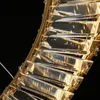 A close-up view of a gold-colored ring-shaped chandelier with many clear crystal elements. Produktbild-Vorschau