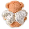 A teddy bear seen from behind, wearing angel wings. Produktbild-Vorschau