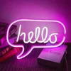 A neon sign shaped like a speech bubble with the word "hello" is displayed in a room, with books in the background. Anteprima dell’immagine prodotto