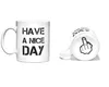 Two white ceramic mugs are shown against a white background. One mug is upright and displays text. The other mug is lying on its side, showing its bottom. Náhled obrázku produktu