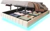 A bed frame with storage, showing the storage compartment open and filled with folded linens. The bed frame has integrated LED lighting. Náhled obrázku produktu