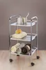 A chrome bathroom cart with three shelves, holding various bathroom items. Náhled obrázku produktu