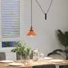 A dining table set with plates, glasses, and a vase of greenery, under a pendant light. Produktbild-Vorschau