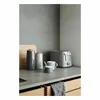 A modern kitchen counter featuring various appliances and serving ware. Náhled obrázku produktu