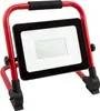 A portable LED work light with a red metal frame and a black housing for the light panel. Produktbild-Vorschau