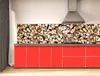 A kitchen with red cabinets and a backsplash made of stacked firewood. Podgląd zdjęcia produktu