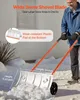 A person is using a snow shovel with wheels in a snowy environment. Podgląd zdjęcia produktu