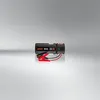 A product shot of a car battery jump starter on a reflective surface with a gradient background. Náhled obrázku produktu