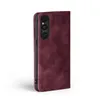 A burgundy flip case for a smartphone, shown from the side with the camera module visible. Produktbild-Vorschau