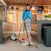 A woman is cleaning a kitchen floor with a steam cleaner. Podgląd zdjęcia produktu