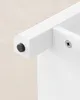 Close-up of a white furniture piece, showing a connection point with a black plug and a screw. Náhled obrázku produktu