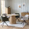 A dining room setting with a round wooden table and four chairs. Voir les images du produit
