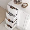 A white bathroom cabinet with several open drawers displaying towels and toiletries. Produktbild-Vorschau