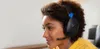 A young person wearing headphones and looking to the side. Produktbild-Vorschau