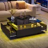 A modern living room scene featuring a black high-gloss coffee table with LED lighting and storage drawers, placed in front of a beige sectional sofa. Produktbild-Vorschau