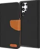 A black flip case for a Samsung Galaxy S23 Ultra phone, shown open to reveal the phone's camera array. Produktbild-Vorschau