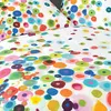 A close-up view of a white duvet cover with a colorful abstract pattern of circles and dots. Produktbild-Vorschau