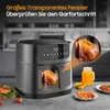 An air fryer with a chicken inside, along with some food items and a drink, set on a kitchen counter. Produktbild-Vorschau