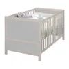A baby crib with bedding and a toy. Produktbild-Vorschau