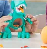 Hands interacting with a teal dinosaur toy on a white table, with an orange ball in the background. Produktbild-Vorschau