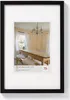 A framed picture of a dining room with a long wooden table and chairs. Produktbild-Vorschau