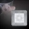 A person is showering while a shower head is shown in the foreground. Produktbild-Vorschau