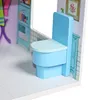 A close-up view of a toy dollhouse bathroom with a blue toilet. Produktbild-Vorschau