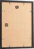 The back of a black picture frame with hanging hardware. Produktbild-Vorschau