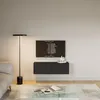 A modern living room with a sofa, coffee table, floor lamp, and a wall-mounted TV unit. Náhled obrázku produktu