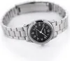 A close-up shot of a silver and black Casio women's watch with a black dial and a metal band, set against a white background. Produktbild-Vorschau