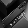 A black phone case with a carbon fiber texture is shown at an angle on a dark, reflective surface. Produktbild-Vorschau