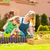 A mother and daughter are gardening together in a sunny backyard. Náhled obrázku produktu
