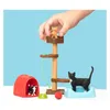A child's hand places a toy cat on a cat tree, surrounded by other toy cat accessories. Anteprima dell’immagine prodotto