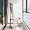 A drying rack with clothes and towels placed on it, positioned near a window. Produktbild-Vorschau