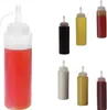 A collection of six squeeze bottles filled with various condiments. Produktbild-Vorschau