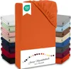 A stack of folded fitted sheets in various colors, with a prominent orange fitted sheet in the foreground. Produktbild-Vorschau
