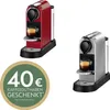 Two Nespresso coffee machines, one red and one silver, are displayed next to a green circular promotional graphic indicating "40€ KAFFEEGUTHABEN GESCHENKT". Anteprima dell’immagine prodotto